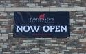 Shown is a 4 foot high x 8 foot wide scrim vinyl banner with reinforced hems all around and grommets every two feet