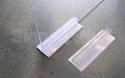 Select optional clear plastic Grip Strips to stabilize the clear panel outer ends - teeth in the upper section grip the panel tight, and foam tape underneath adheres to desks and tables to help prevent movement